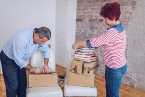 An older married couple is moving into a new apartment